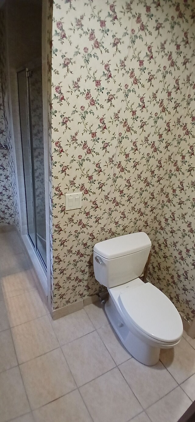 bathroom with tile patterned floors and toilet