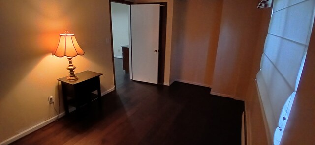 hall with dark hardwood / wood-style flooring