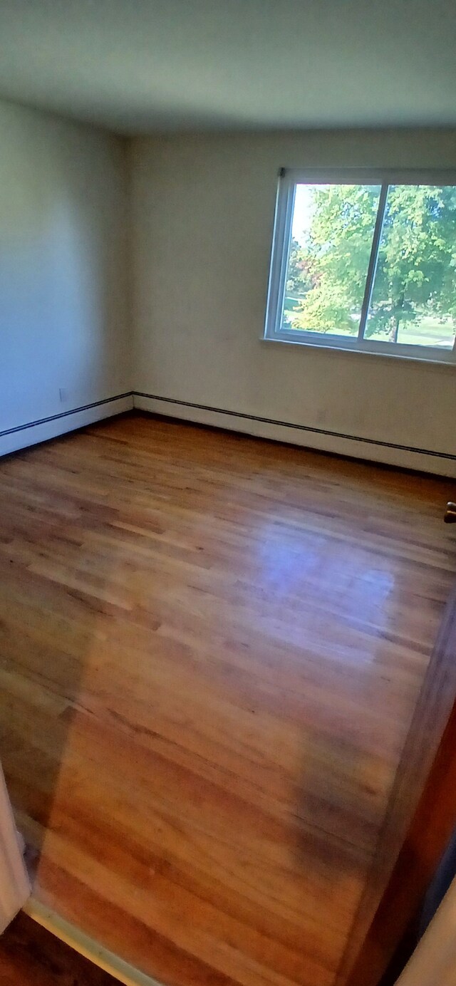 spare room featuring hardwood / wood-style floors