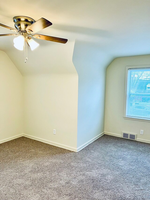 additional living space featuring carpet flooring, ceiling fan, and vaulted ceiling