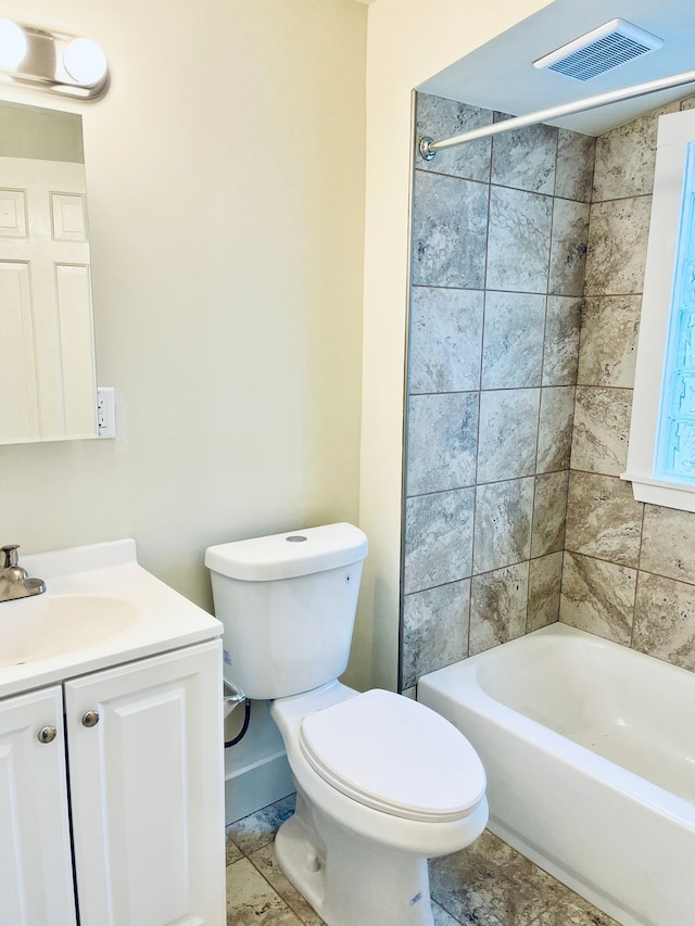 full bathroom with vanity, toilet, and tiled shower / bath combo