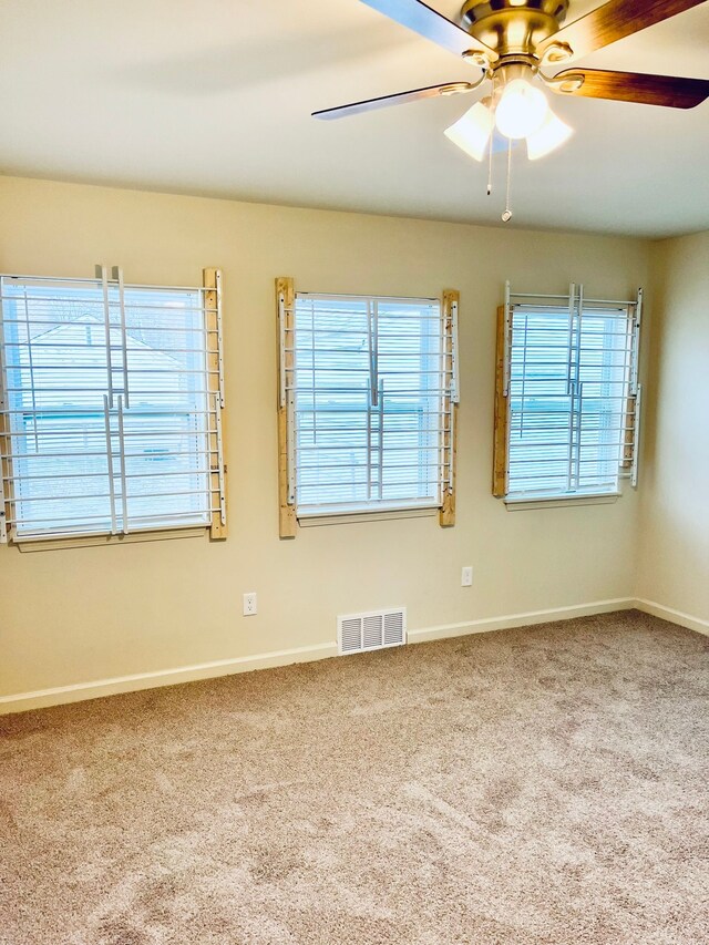 carpeted empty room with ceiling fan