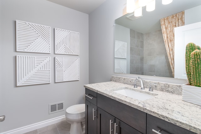 bathroom featuring tile patterned floors, vanity, and toilet