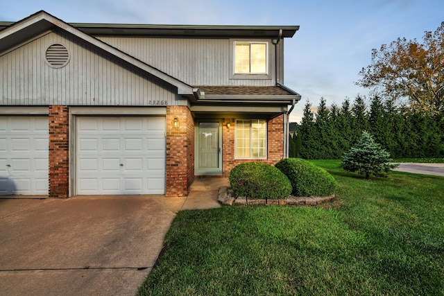 view of front of house featuring a garage and a yard