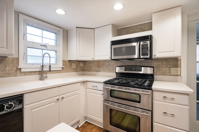 kitchen with white cabinets, sink, and appliances with stainless steel finishes