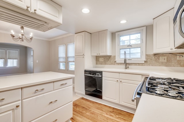 kitchen featuring backsplash, light hardwood / wood-style flooring, white cabinets, and white appliances