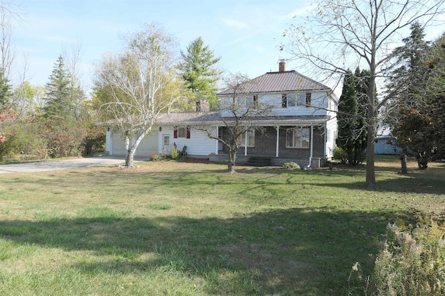 view of front facade featuring a front lawn, covered porch, and a garage