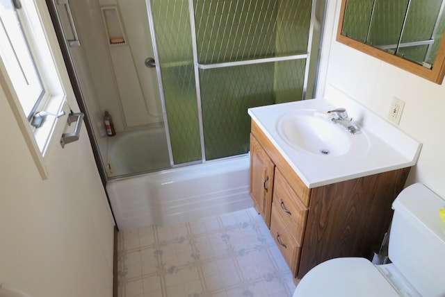 full bathroom with toilet, vanity, and combined bath / shower with glass door