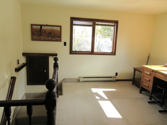 exercise room featuring carpet and a baseboard heating unit