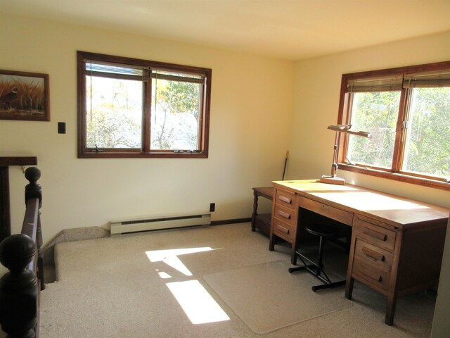 home office featuring light carpet, plenty of natural light, and a baseboard heating unit