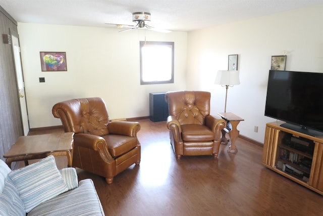 living room with dark hardwood / wood-style floors and ceiling fan