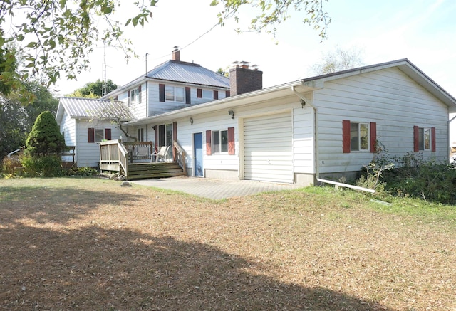 back of property featuring a patio area and a deck