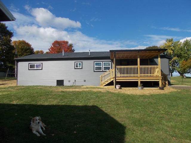 back of property with a lawn and a wooden deck