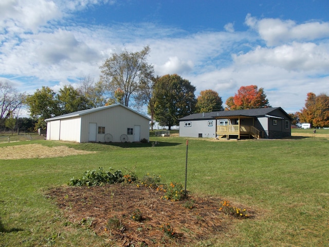 view of yard with a wooden deck and an outbuilding