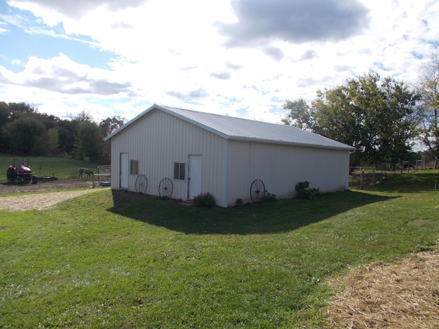 view of property exterior with a yard and an outdoor structure