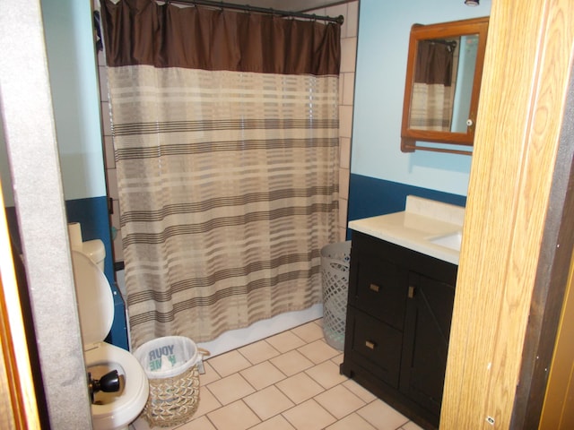 bathroom featuring tile patterned flooring, vanity, and a shower with shower curtain