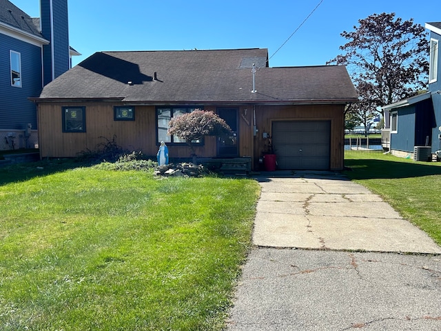 view of front facade featuring central AC unit, a garage, and a front lawn