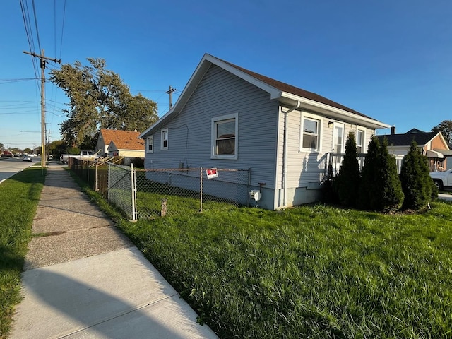 view of side of property with a lawn