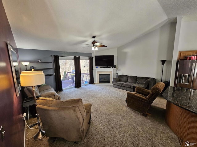 carpeted living room with ceiling fan, a textured ceiling, and vaulted ceiling