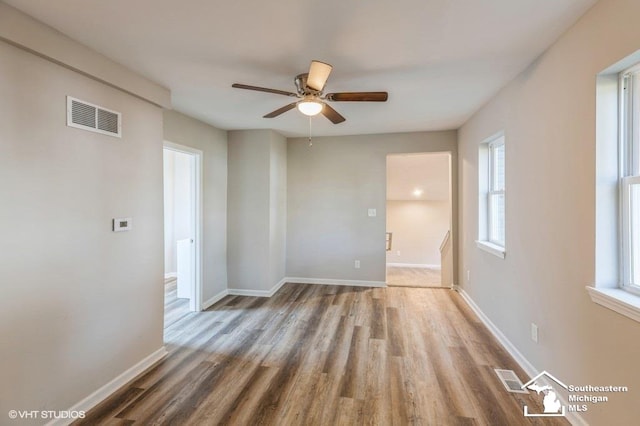 empty room featuring hardwood / wood-style floors and ceiling fan