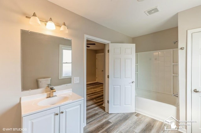 full bathroom with vanity,  shower combination, toilet, and wood-type flooring