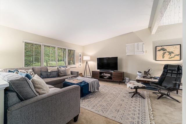 carpeted living room featuring lofted ceiling