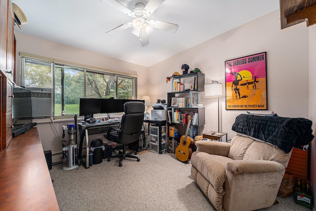 carpeted office featuring baseboard heating and ceiling fan