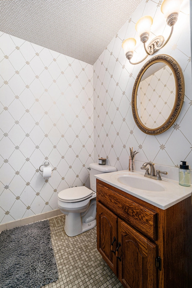 bathroom featuring tile patterned floors, vanity, and toilet