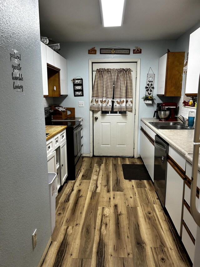 3714 W Hastings Lake Rd, Jonesville, MI 49250 - kitchen with electric range, dishwasher, a sink, light wood finished floors, and white cabinets