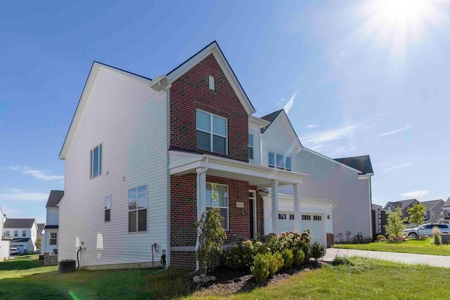 front facade featuring a front yard and a garage