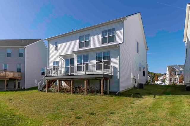 back of property featuring a lawn, a deck, and central air condition unit