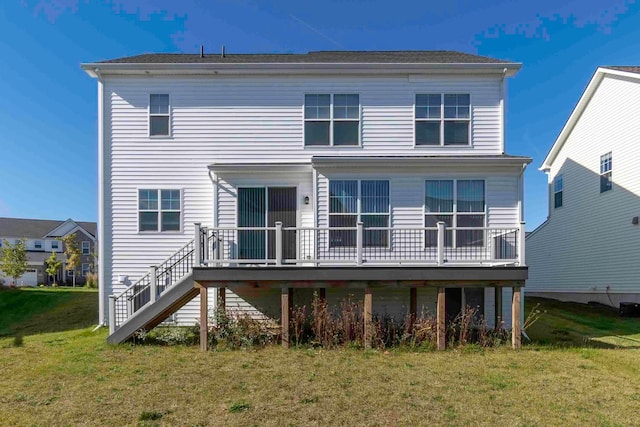 rear view of property featuring a yard and a deck