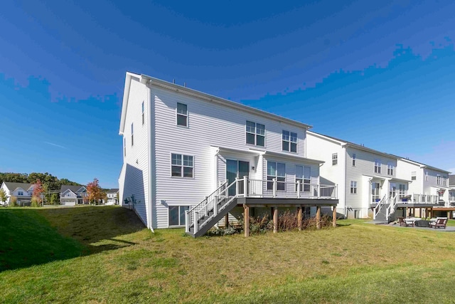 back of house with a yard and a wooden deck