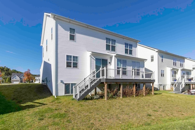 back of house featuring a yard and a wooden deck