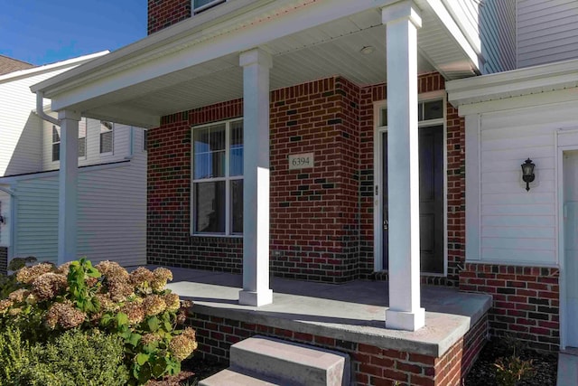 view of exterior entry with a porch