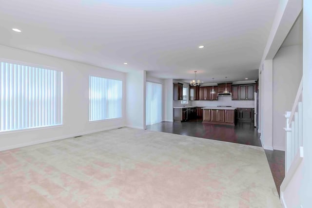 unfurnished living room with an inviting chandelier