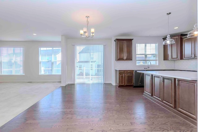 kitchen with dishwasher, hanging light fixtures, and plenty of natural light