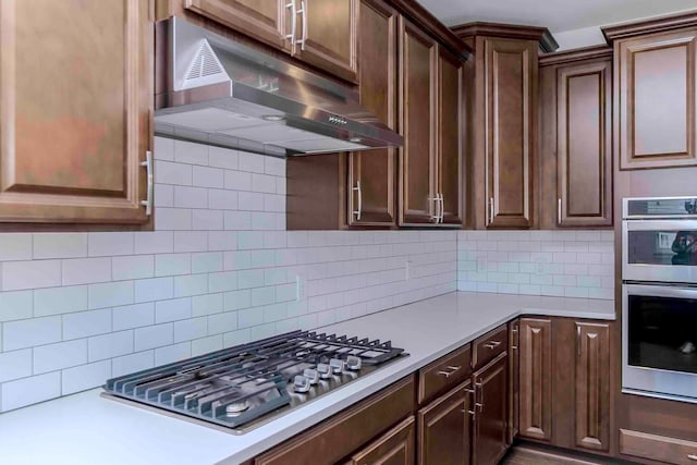 kitchen with tasteful backsplash and appliances with stainless steel finishes