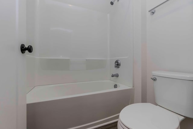 bathroom with shower / bathing tub combination and toilet