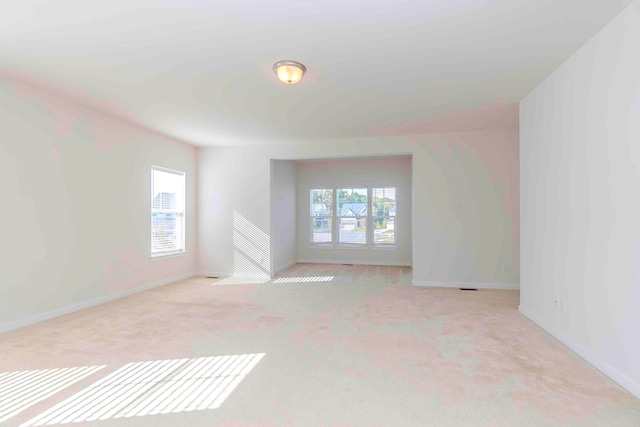 empty room with light carpet and a healthy amount of sunlight