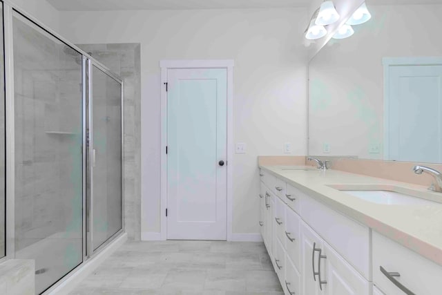 bathroom with vanity and a shower with shower door