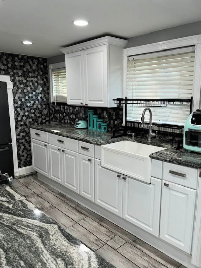 kitchen with refrigerator, white cabinetry, and a healthy amount of sunlight