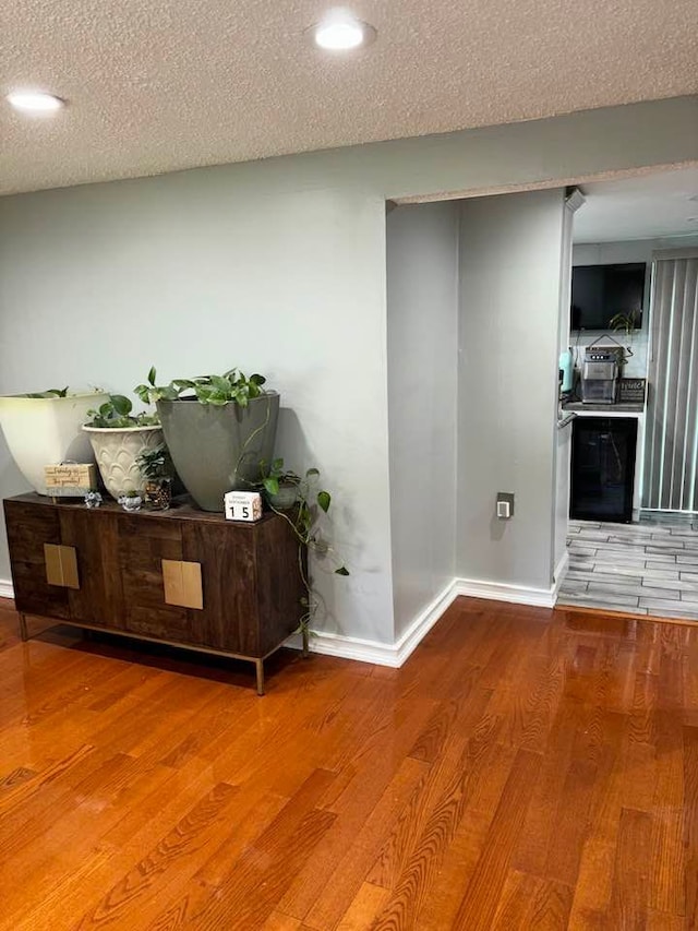 interior space featuring wood-type flooring and a textured ceiling