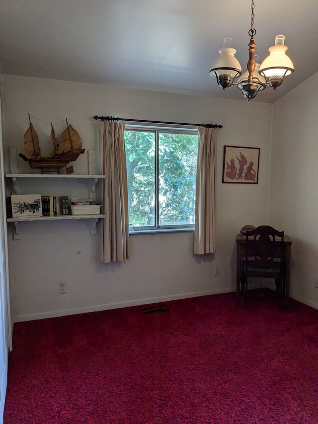 spare room with carpet flooring and a notable chandelier