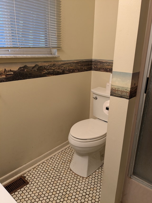 bathroom featuring tile patterned floors and toilet