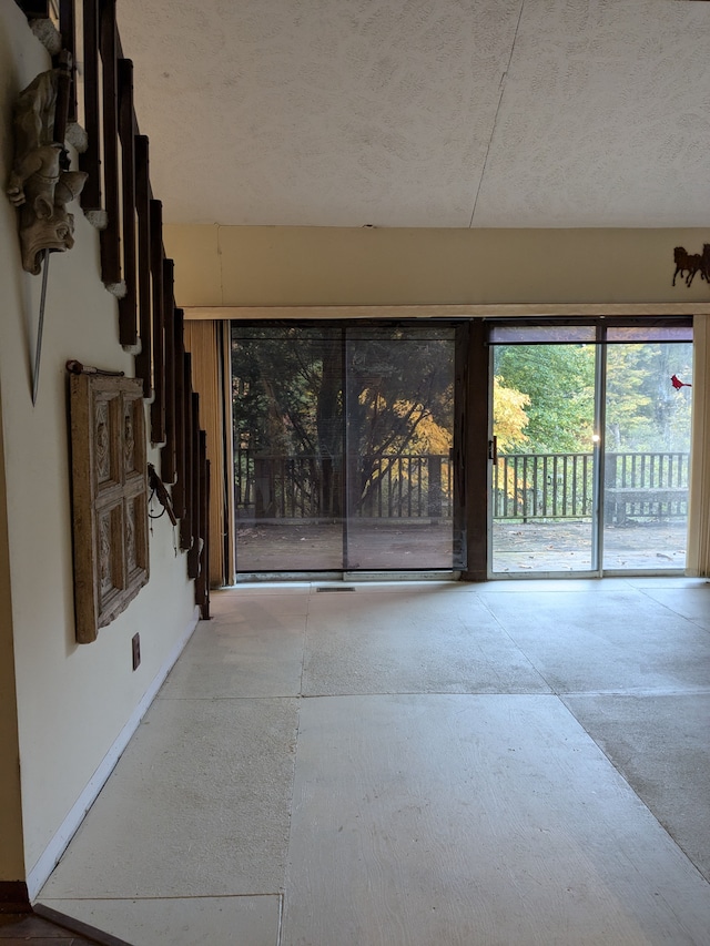 unfurnished living room with a textured ceiling