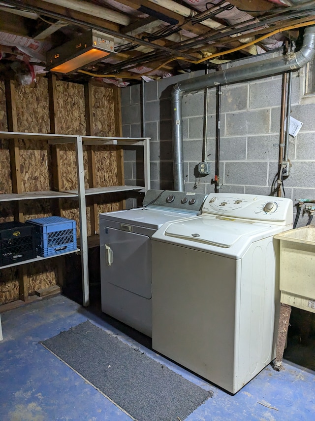 washroom featuring washer and dryer and sink