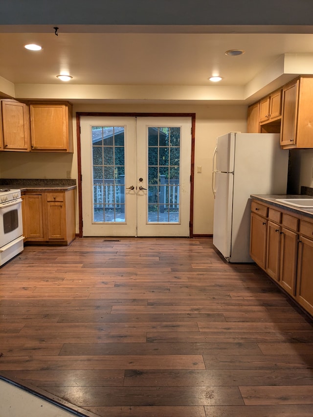 kitchen featuring french doors, dark hardwood / wood-style flooring, white appliances, and sink