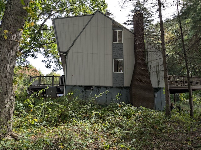 view of side of home featuring a wooden deck