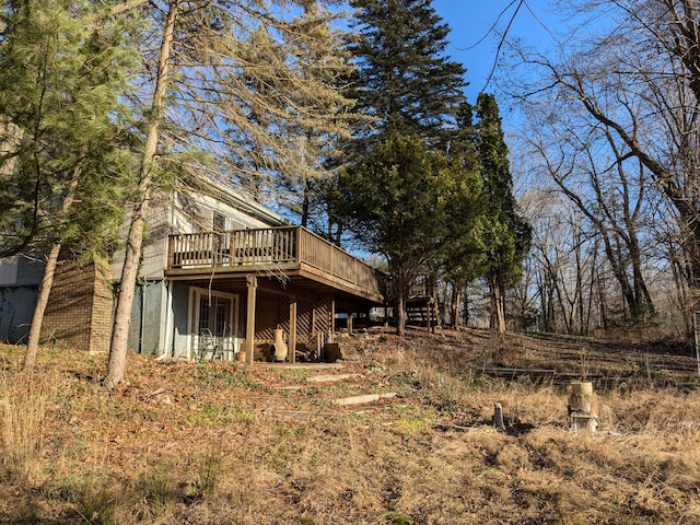 back of house featuring a wooden deck